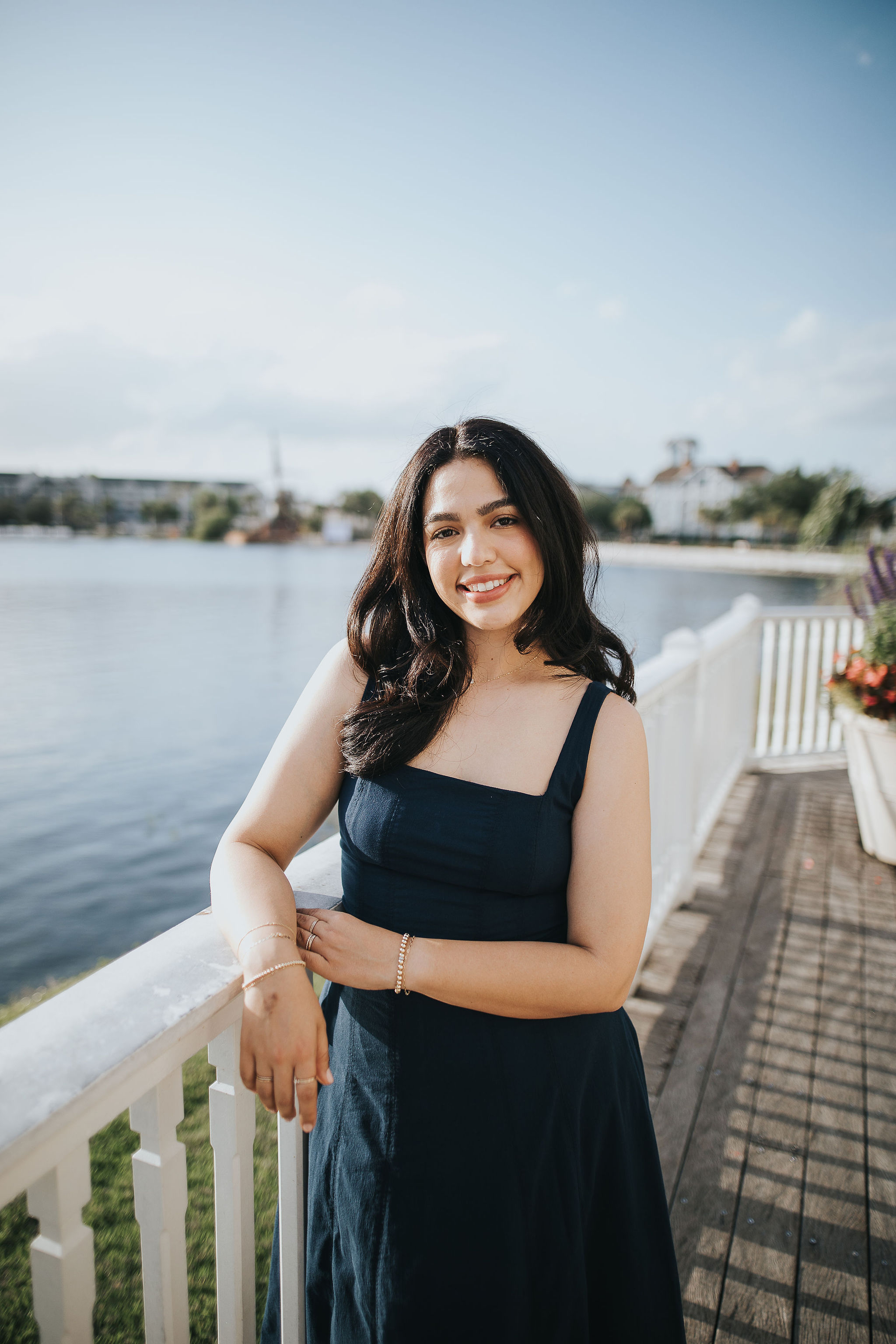 Cindy, founder of Destino Collection, smiling on a waterfront terrace