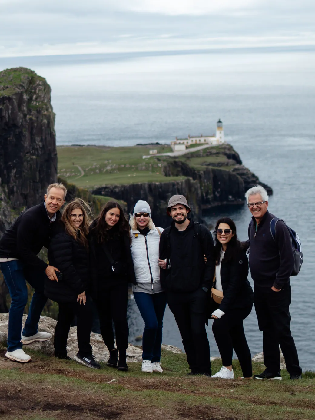 A travel group on the cliffs above Neist Point lighthouse, Isle of Skye